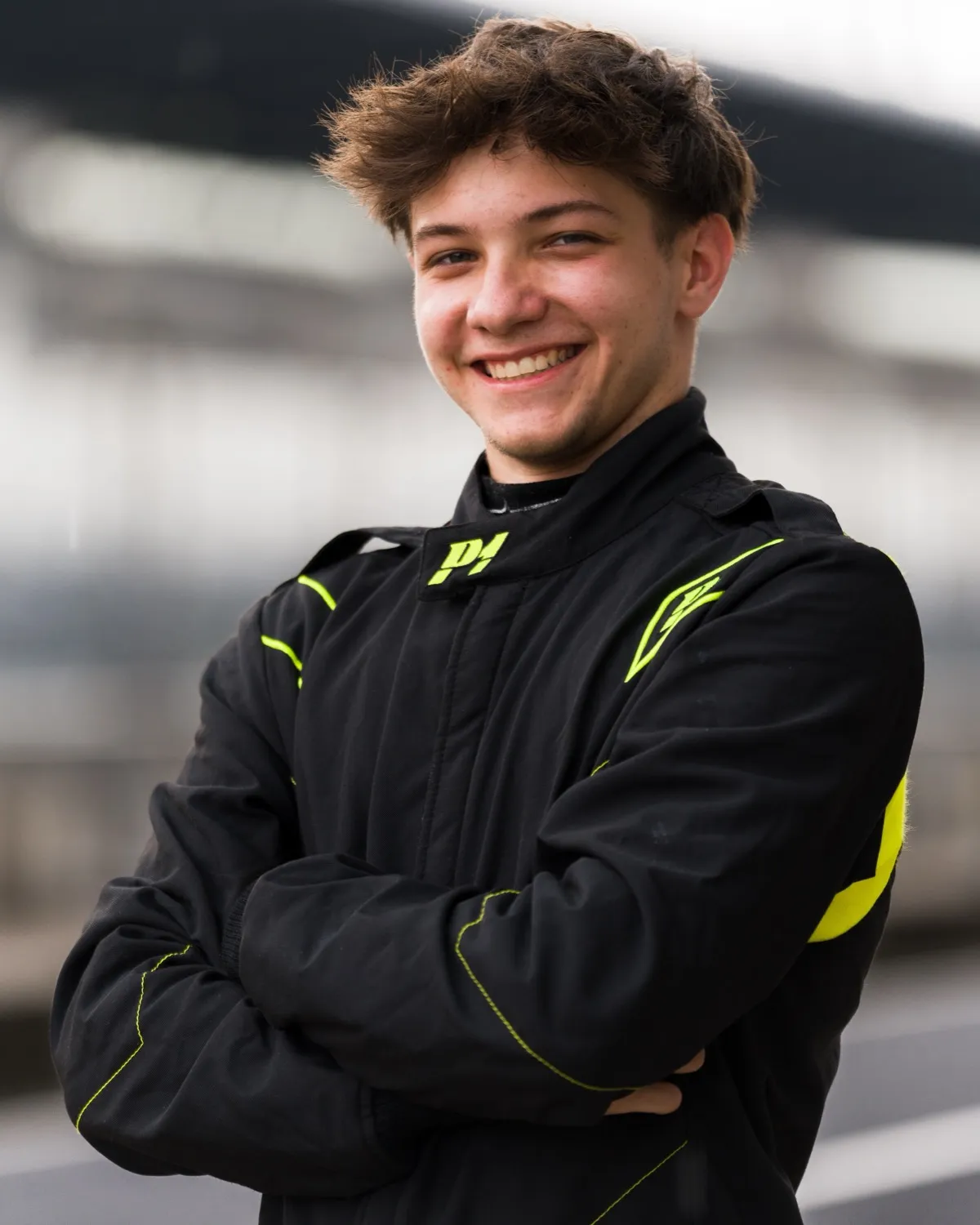 Siro Zambra in his race suit in the pit lane, smiling